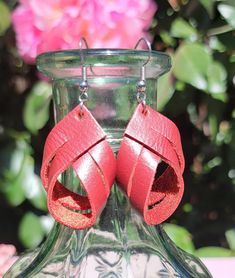 These charming deep red leather twist earrings are 1-1/2  inch long.  That is the length of the leather. Please see photos for the overall length.  They are the perfect size to enhance your outfit without being to bold. They are lightweight, you will forget that you are wearing them. I would suggest keeping them out of water. Leather tends to get spotted and can shrink.  They are suited for sensitive ears.  **USUALLY SHIPS NEXT DAY  *Nickle free hooks  PLEASE SEE PHOTOS FOR TOTAL LENGTH. GET COMPLIMENTS 😎 They look good with casual clothes, work clothes or a night out on the town with jeans and a shirt. They are subtle beauties. I'm sure you will get plenty of compliments! They also make great  gifts for someone special like your Bestie, Mom, daughter Aunt co-worker. You get the picture. Red Leather Earrings For Gifts, Adjustable Red Leather Earrings, Red Leather Earrings, Twist Earrings, Casual Clothes, Mom Daughter, Work Clothes, Sensitive Ears, Deep Red