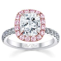 a cushion cut diamond ring with pink and white diamonds