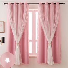 pink curtains hanging on the side of a window