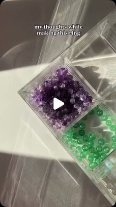 there is a plastic container with beads in it and a video playing on the screen