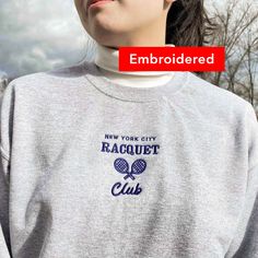 "*SIZES ARE UNISEX* -I'd suggest your usual size for a regular fit, or sizing up for a more relaxed fit. *these sweatshirts are extra comfy when oversized 🏸 \"New York City Racquet Club\" embroidered in navy on a comfy vintage-style crewneck. This cute crewneck is inspired by brandy melville and vintage nike sweatshirts. Perfect for any occasion or gift for him or her. A sturdy and warm sweatshirt bound to keep you warm in the colder months. A pre-shrunk, classic fit sweater that's made with ai Cotton Tennis Sweatshirt With Relaxed Fit, Cotton Tennis Sweatshirt In Relaxed Fit, Cotton Crew Neck Tennis Sweatshirt, Cotton Crew Neck Sweatshirt For Tennis, Long Sleeve Relaxed Fit Sweatshirt For Tennis, Casual Relaxed Fit Sweatshirt For Tennis, Sporty Crew Neck Sweatshirt With Embroidered Graphics, Embroidered Crew Neck Sweatshirt For Sports Season, Crew Neck Tennis Sweatshirt For Sports Season