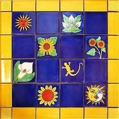 a yellow and blue tiled wall with sunflowers, lizards, and other decorative items