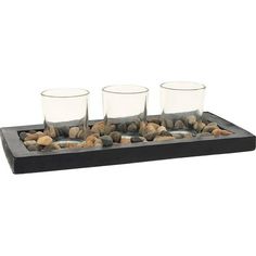 three glasses and rocks on a tray