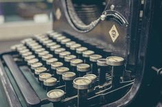 an old fashioned typewriter with lots of buttons