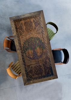 an overhead view of a table with chairs and a tree design on the back wall