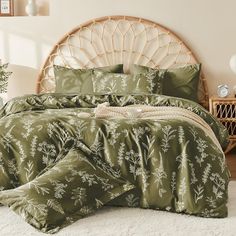 a bed with green comforters and pillows