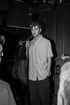 a man standing in front of a microphone