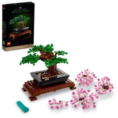 a lego tree with pink flowers and green leaves in it's box next to its contents