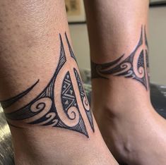 two people with matching tattoos on their legs