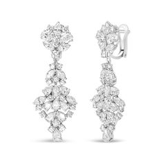 Brimming with the vivacious sparkle of natural, white diamonds, these dazzling drop earrings for her feature marquise, oval, pear, and round shaped diamonds in a prong-setting and arranged in a cluster design. These geometric-inspired cluster earrings form a decadent display of shimmering beauty and are styled for length to capture an eye-catching dangle that catches the light as you move. Fashioned in genuine 18k white gold, the total diamond weight is 9 1/2 carat and the diamonds are of an approximate F-G color and VS1-VS2 clarity. The earrings secure with clip on backs for sizzling nighttime styling. Cluster Design, Geometric Inspiration, Cluster Earrings, American Jewelry, Diamond Cluster, 2 Carat, White Diamonds, Diamond White, Prong Setting