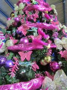 a christmas tree decorated with pink and purple ornaments