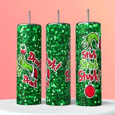 three green sparkle candles with stickers on them