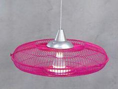 a pink light hanging from a ceiling fixture