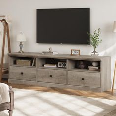 a living room with a large flat screen tv mounted on the wall and drawers in front of it