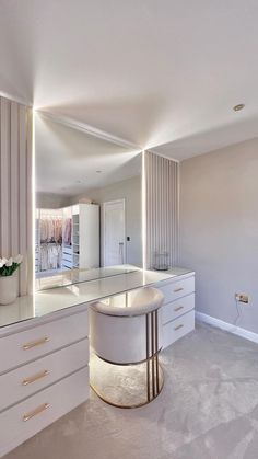 a large mirror in the middle of a room next to a sink and counter top