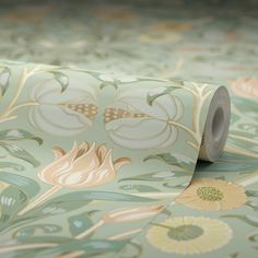 a roll of wallpaper with flowers and leaves printed on it's side,