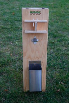 a wooden water dispenser in the grass