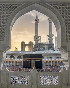 the kabab is surrounded by many people in front of an ornate white building