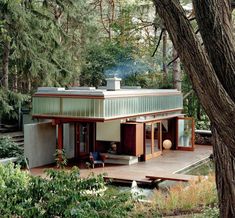 a small house in the woods surrounded by trees