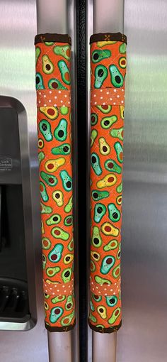 an orange and green pattern on the handles of a refrigerator