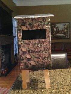 a realtree camo box sitting on top of a counter next to a fireplace