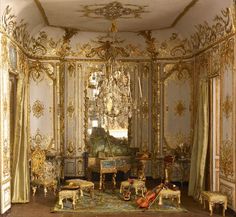 an elaborately decorated room with furniture and chandelier