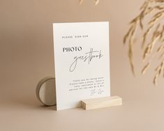 a photo greeting card sitting on top of a table next to a rock and plant