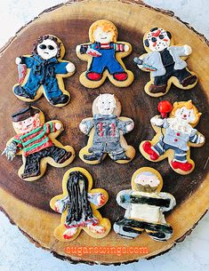 decorated cookies in the shape of children's characters on a wooden platter with text overlay