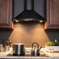 a stove top oven sitting inside of a kitchen next to wooden cabinets and counter tops