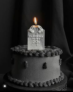 a black and white photo of a cake with a lit candle on top that says farewell to my 205