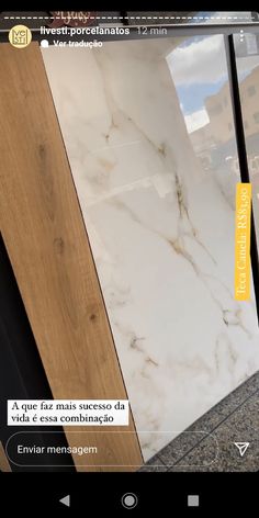 a white marble counter top sitting on top of a wooden floor next to a door