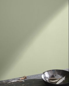 a black bowl sitting on top of a wooden table