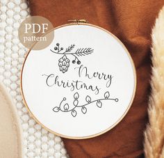 a cross stitch pattern with the words merry christmas written in cursive font on it