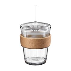 a glass cup with a cork lid and straw sticking out of the top, on a white background