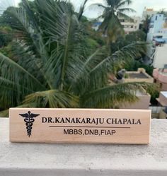 a wooden plaque that says dr kankaarau chapla on top of a building