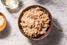 two bowls filled with food sitting on top of a table