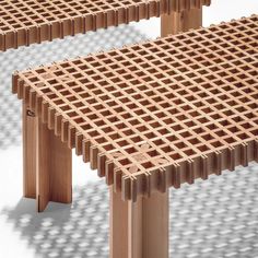 two wooden benches sitting next to each other on top of a white surface with holes in it