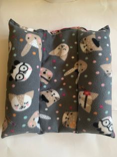 two decorative pillows on a white surface, one with an animal pattern and the other with pandas