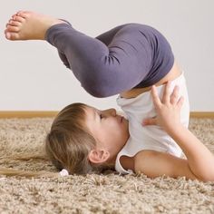 a young child is playing on the carpet