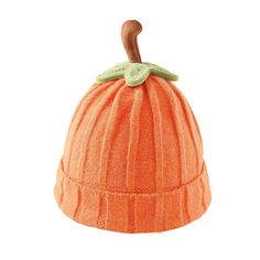 an orange knitted hat with a green leaf on the top and a wooden handle