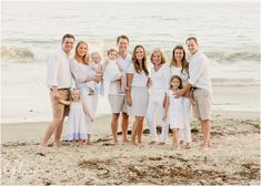 a family posing for a photo on the beach