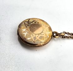 Gold filled etched locket mid century photo necklace. Good used condition with little to no signs of normal wear. Chain has early thumb clasp. Etched with the number 16 on the inside of each side of locket. Comes with vintage picture and frame. Necklace measures 15.5 inches long. Locket measures 5/8ths of an inch across. Antique Etched Medallion Locket Necklace, Vintage Etched Locket Necklace For Keepsake, Vintage Locket Necklace For Keepsake, Antique Filigree Round Pendant Locket Necklace, Vintage Etched Locket Necklace With Round Pendant, Vintage Filigree Medallion Locket Necklace, Vintage Etched Round Locket Necklace, Keepsake Medallion Necklace With Etched Details, Costume Jewelry Medallion Locket Necklace