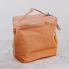 an orange bag sitting on top of a marble counter