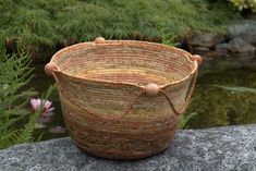 a woven basket sitting on top of a rock