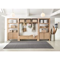 a living room filled with furniture and lots of storage space on top of it's shelves