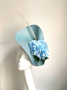 Light blue Hydrangea Hat Light blue Hydrangea Hat will be an amazing accessory to compliment your outfit. The colours can easily pick the colours you would be wearing. A light blue saucer disc hat will fit an average head size. It's made from fabric covered metal headband attached to a light blue colour polybraid saucer disc which sits two white/cream colour Feathers and hydrangea flowers to match the hat.  To secure your fascinator there is a comb inside the hat attached to the headband, so the Light Blue Hydrangea, Blue Fascinator, Kentucky Derby Fascinator, Royal Ascot Hats, Derby Fascinator, Hat Light, Metal Headband, Hydrangea Flowers, Wedding Hat