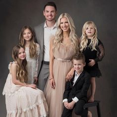 a family posing for a photo in formal wear