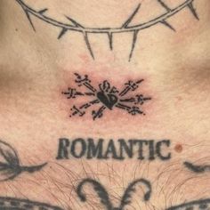 the chest is adorned with tattoos and barbed wire above it, which reads romantic love