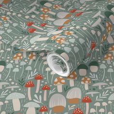 a green wallpaper with mushrooms and leaves on the ground, as well as a roll of paper