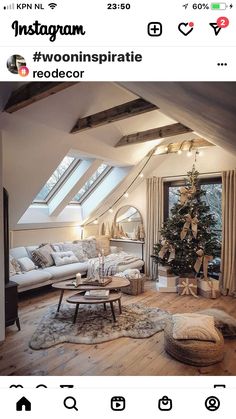 a living room filled with furniture and a christmas tree on top of a wooden floor